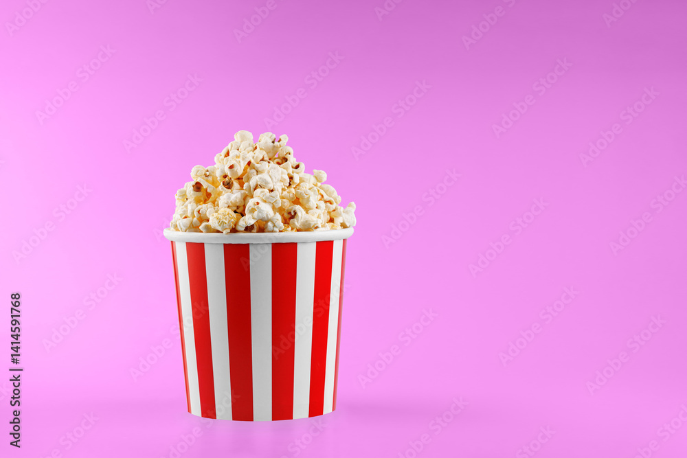 Classic red striped popcorn cardboard cup on Pink background