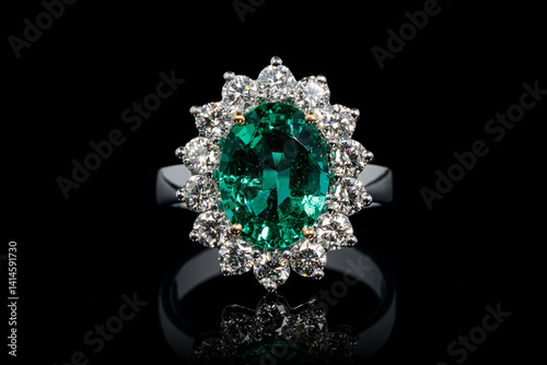 Obraz na płótnie silver or gold ring with emerald stone and diamonds on black background w salonie