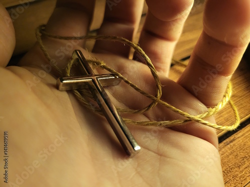 Hand Holding Christian Cross Pendant – Symbol of Faith and Devotion