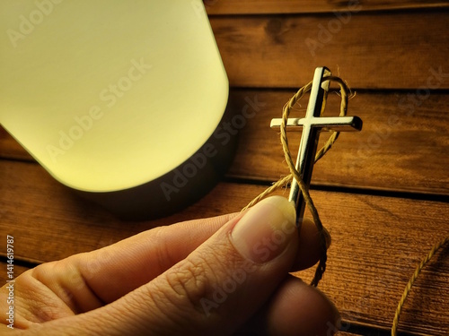 Hand Holding Christian Cross Pendant – Symbol of Faith and Devotion