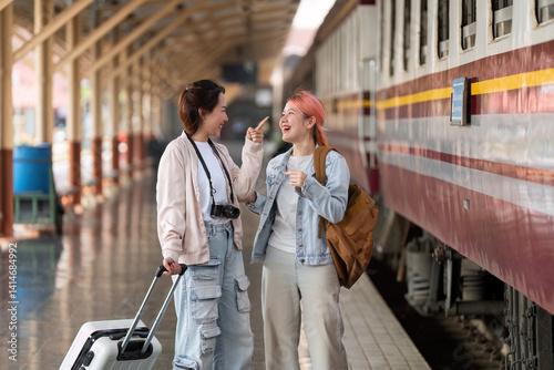 Travel Adventure and Friendship. Two friends sharing excited moments at the train station before embarking on their journey.