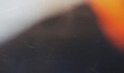 grainy colorful warm orange light leaks on black background with dust texture. abstract damaged scratched retro film analog effect for using over photos as overlay or screen filter