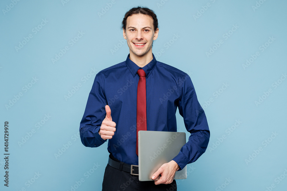 Young employee IT business man corporate lawyer he wear classic formal shirt red tie work in office hold closed laptop pc computer show thumb up like isolated on plain blue background studio portrait Young employee IT business man corporate lawyer he wear classic formal shirt red tie work in office hold closed laptop pc computer show thumb up like isolated on plain blue background studio portrait