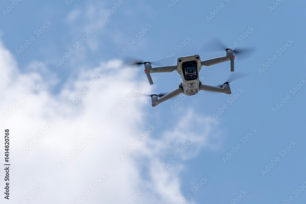 A Small Drone Flying in the Sky on a Bright Sunny Day