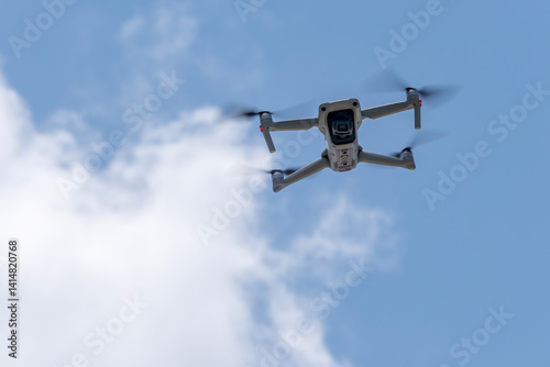 Obraz na płótnie A Small Drone Flying in the Sky on a Bright Sunny Day w salonie