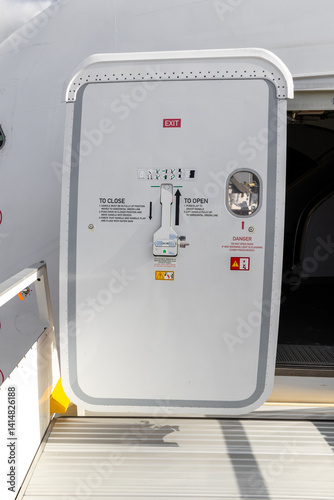 Open aircraft passenger door as seen from the stairs.