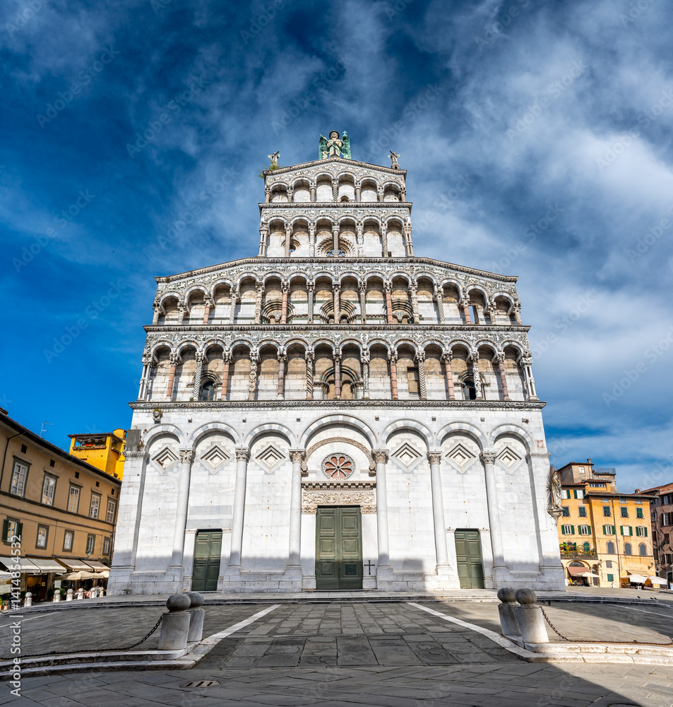 Panoramic view of Chiesa di San Michele in Foro in the historic center of Lucca Italy on a sunny summer day with clear blue sky and warm light on the ancient architecture