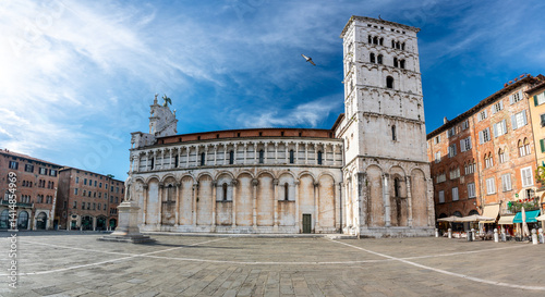 Panoramic view of Chiesa di San Michele in Foro in the historic center of Lucca Italy on a sunny summer day with clear blue sky and warm light on the ancient architecture