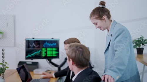 Team collaborates on financial strategy in modern office environment with technology