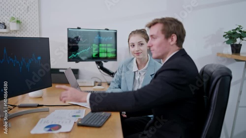 Professionals analyzing data trends in a modern office environment during work hours