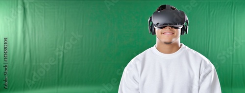 Obraz na płótnie Youth experiences immersive virtual reality gaming, fully engaged with VR glasses and headphones in a bright green setting w salonie