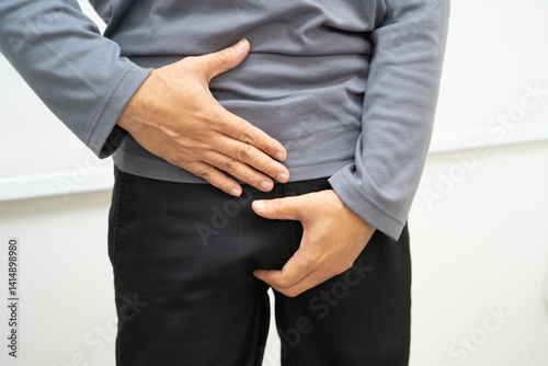 Hernia, Asian man stomach ache, abdominal pain and urology problem health.