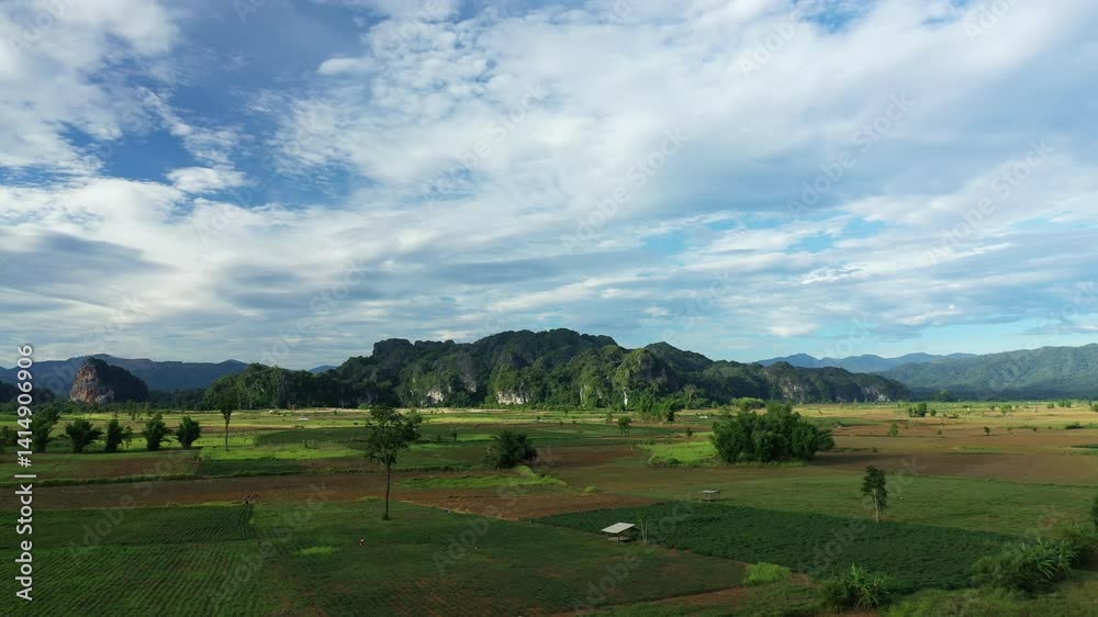 Peasant houses in the middle of the countryside and mountainous terrain in Asia, Laos, in Khammouane, near Thakek, on a sunny day. Peasant houses in the middle of the countryside and mountainous terrain in Asia, Laos, in Khammouane, near Thakek, on a sunny day.