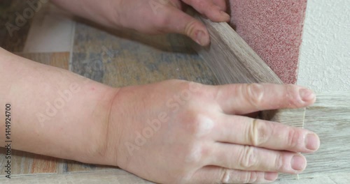 Corner connection of the skirting board. A man installs a plastic skirting board on the floor of an apartment.