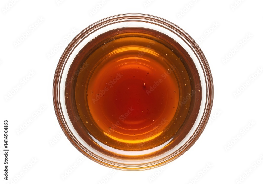Golden syrup in a bowl top view for food photography ideas isolated on white background Golden syrup in a bowl top view for food photography ideas isolated on white background