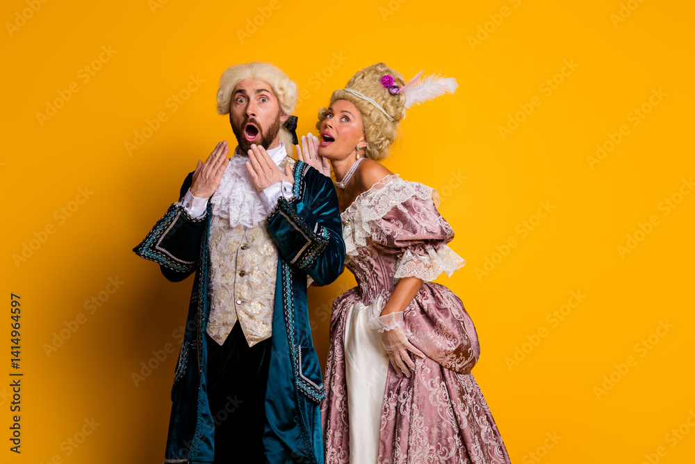 Fototapeta premium Couple in Elegant Period Costumes Against Vibrant Yellow Background