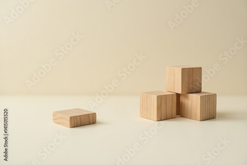 Simple wooden blocks arranged on a neutral background, illustrating concepts of building, structure, and design