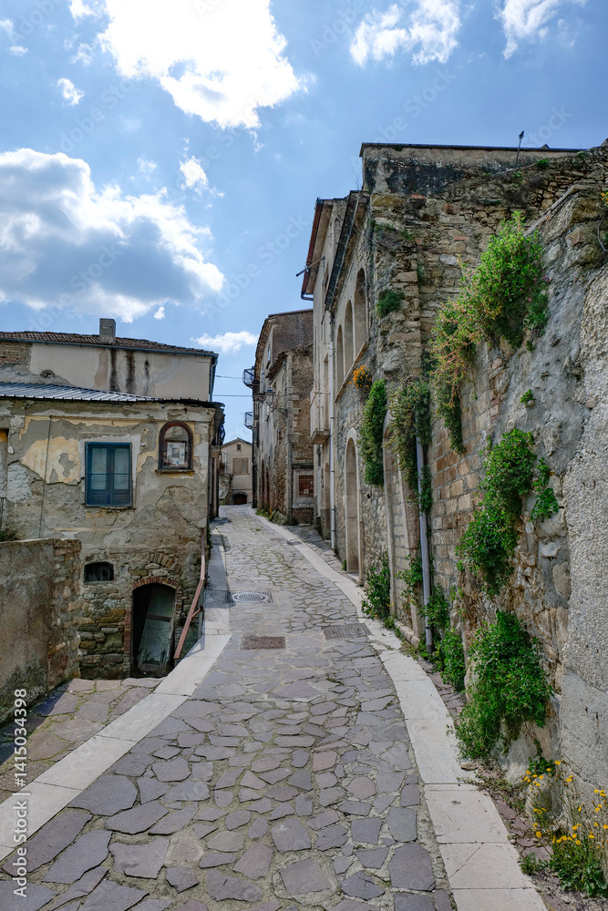A narrow street between the old houses of San Giorgio la Molara in Campania, Italy.