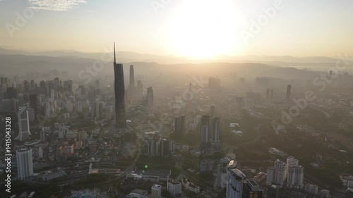 Aerial view cinematic establishing shoot of Kuala Lumpur city center view at sunrise dawn overlooking the city skyline in Federal Territory, Malaysia