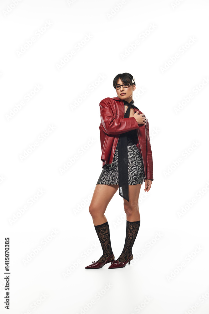 Stylish young woman makes a bold fashion statement in contemporary urban setting Stylish young woman makes a bold fashion statement in contemporary urban setting