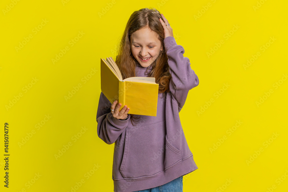 Happy relaxed smiling preteen child girl kid reading funny interesting fairytale story book, leisure hobby, knowledge wisdom, education, learning, study, wow. Children isolated on yellow background Happy relaxed smiling preteen child girl kid reading funny interesting fairytale story book, leisure hobby, knowledge wisdom, education, learning, study, wow. Children isolated on yellow background