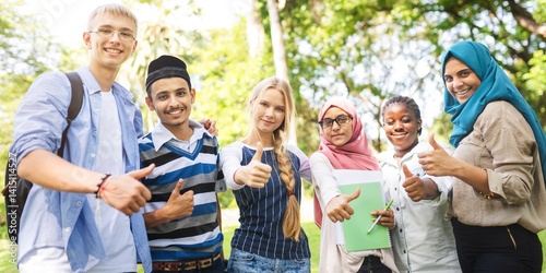 Canvas Print Diverse group of young students smiling and giving thumbs up