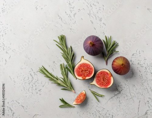 Flatlay of halved figs and rosemary sprigs on light stone background, high-end aesthetic.