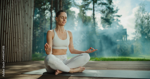 Caucasian Woman Meditates Outdoors, Practicing Mindfulness on a Wooden Deck Surrounded by Nature. Peaceful Demeanor Highlights a Harmonious Connection With the Tranquil Environment photo