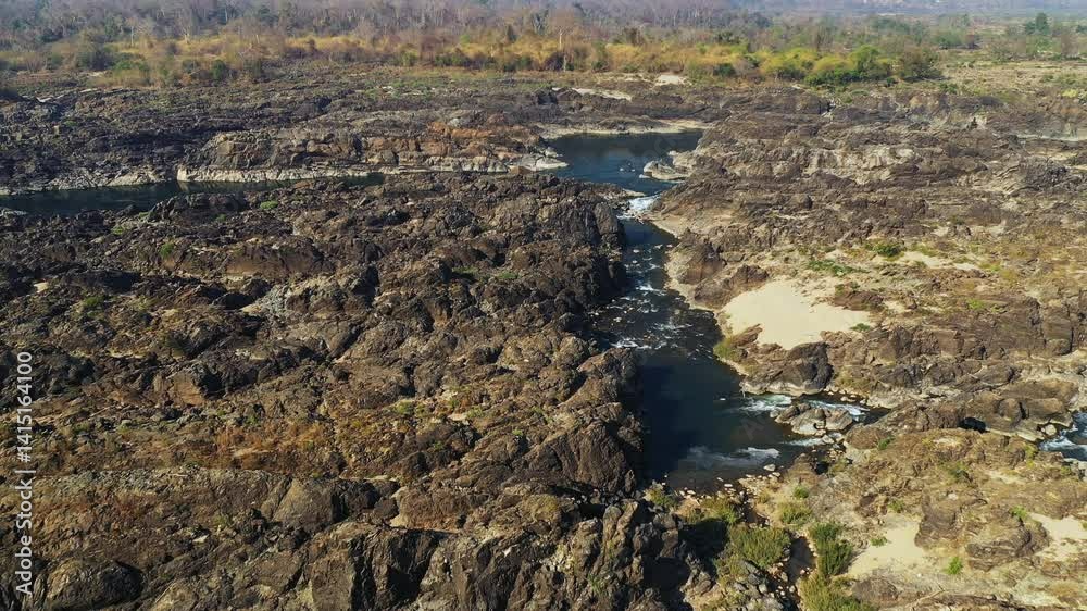 The dry plain near Li Phi Falls in Asia, Laos, Champasak, 4000 Islands, Don Det, on a sunny day. The dry plain near Li Phi Falls in Asia, Laos, Champasak, 4000 Islands, Don Det, on a sunny day.