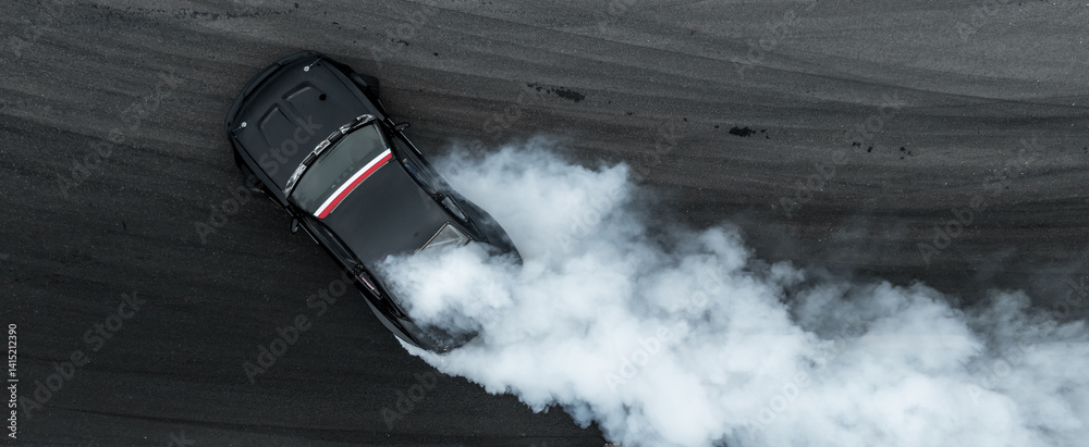 Aerial view car drift on asphalt race track with lot of smoke from burning wheel tires rubber, Drift motorsport car drift race, Professional driver drift car on asphalt race track, Car motion blurred