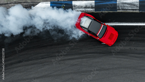 Obraz na płótnie Aerial view car drift on asphalt race track with lot of smoke from burning wheel tires rubber, Drift motorsport car drift race, Professional driver drift car on asphalt race track, Car motion blurred w salonie