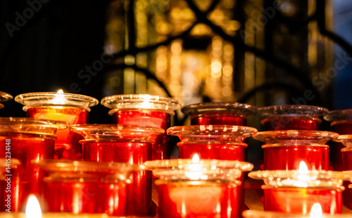 Velas encendidas en un templo religioso con un fondo borroso
