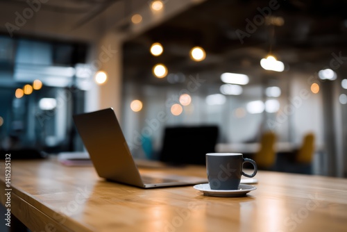 Wallpaper Mural Modern office workspace with wooden desk, open laptop and coffee cup, soft lighting creating comfortable quiet atmosphere. Torontodigital.ca