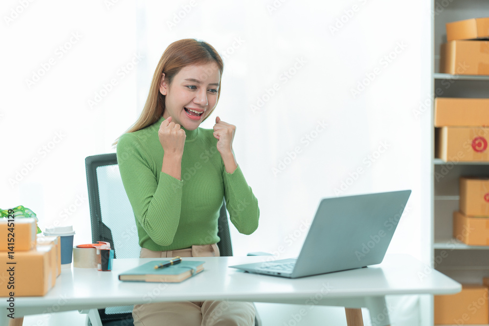Asian woman she is excited and smiling to receive new order name size working with packaging box to write customer address in post box to send product sold online. Asian woman she is excited and smiling to receive new order name size working with packaging box to write customer address in post box to send product sold online.