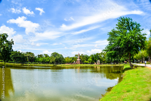 Ancient Pagoda Reflected in Lake at Sukhothai Historical Park, Thailand


