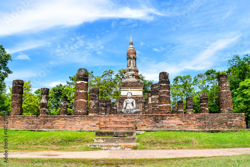Ancient Buddha statue and ruins of old temple in Sukhothai Historical Park, Thailand