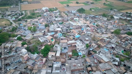 Drone Footage of Overpopulated Indian(Punjab) Village with Packed Houses and Crop Fields

 photo