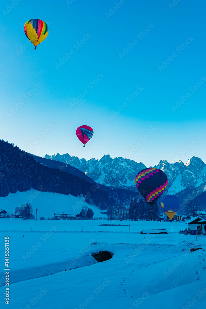 Alpine winter view with hot air balloons at Gosau, Abtenau, Salzkammergut, Salzburg, Austria