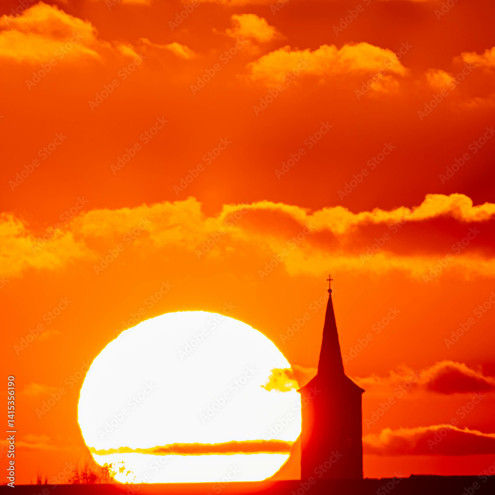 Megazoom (600mm) winter sunset or sundowner with a church silhouette near Haunersdorf, Otzing, Deggendorf, Bavaria, Germany