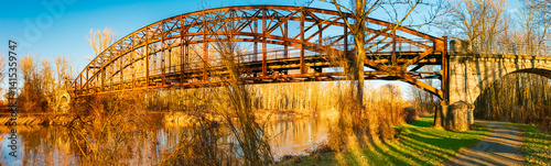Obraz na płótnie Winter landscape with an old railway bridge and reflections on a sunny evening near Landau an der Isar, Dingolfing-Landau, Bavaria, Germany w salonie
