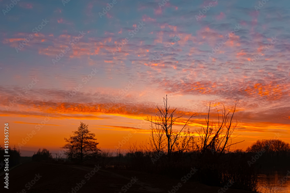 Fototapeta premium Sunset with reflections near Plattling, Isar, Bavaria, Germany