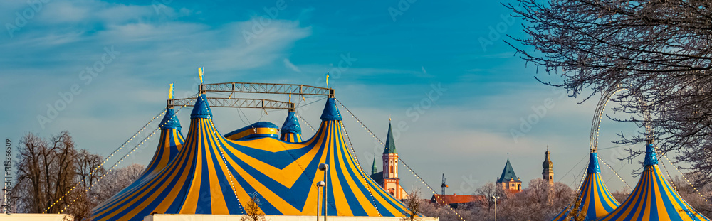 A church and yellow blue circus tents on a sunny winter day at Straubing, Straubing-Bogen, Bavaria, Germany