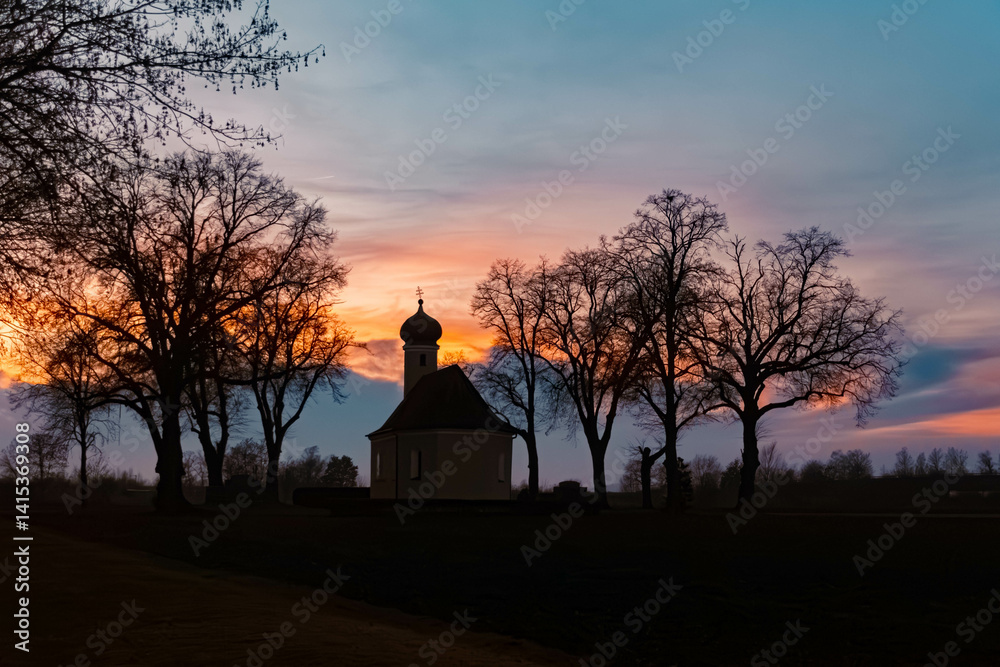 Sunset with a church silhouette near Wallersdorf, Dingolfing-Landau, Bavaria, Germany
