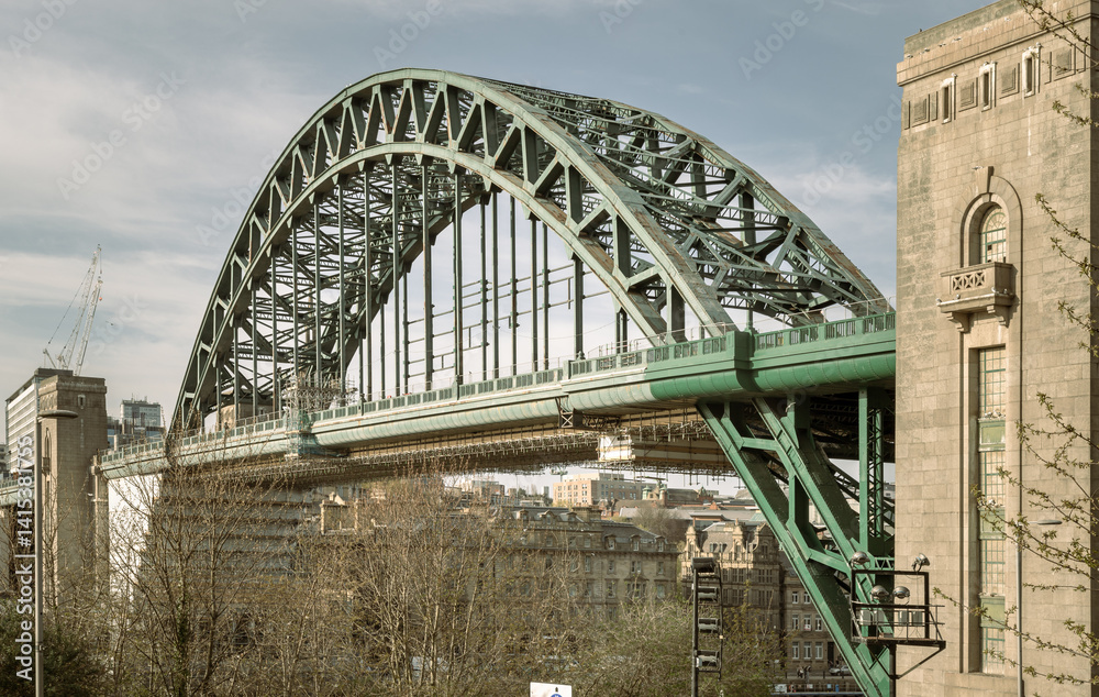 View of Tyne Bridge featured at a dynamic angle showing the parabolic arch of the bridge spanning spanning the River Tyne in Newcastle Upon Tyne in the North East of England. use it as your Wallpaper.