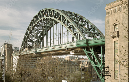 Obraz na płótnie View of Tyne Bridge featured at a dynamic angle showing the parabolic arch of the bridge spanning spanning the River Tyne in Newcastle Upon Tyne in the North East of England. use it as your Wallpaper. w salonie