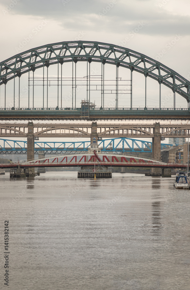 Stunning view of the Newcastle upon tyne with Tyne bridge, Swing bridge and The High level bridge spanning the River Tyne connecting Newcastle upon tyne and Gateshead in North East England. sunset.