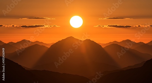 Mountain Range Silhouette at Sunset with Golden Sky and Sun