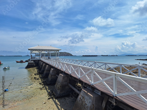 Ashdang Bridge is a white wooden bridge that extends into the sea. Koh Sichang island of Chonburi province, Thailand.