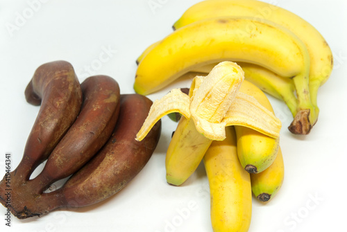 yellow and brown bananas on white background