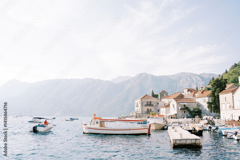 Fototapeta premium Boats are moored at the pier of the ancient town of Perast. Montenegro